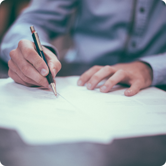 man signing a contract